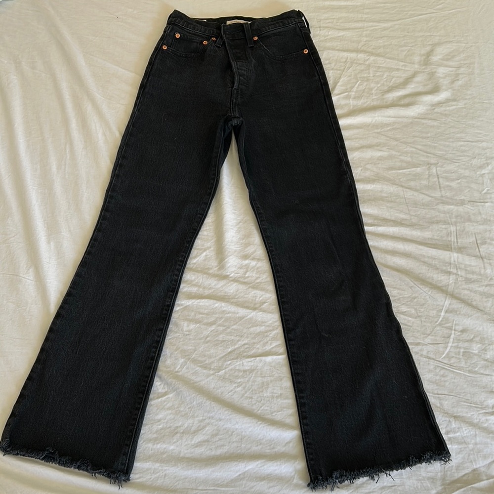 Levis! High waisted, raw hem rib cage flare. Dark charcoal wash.
